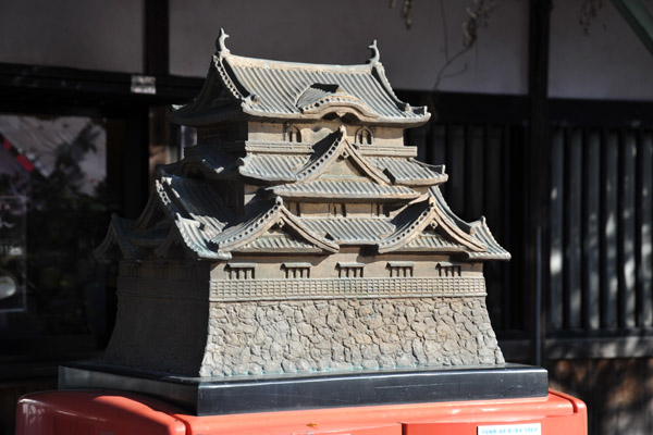 Japanese postbox with a bronze sculpture of the keep of Hikone Castle