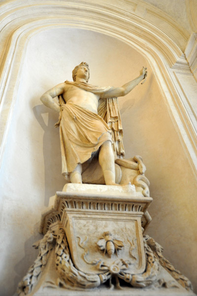 Each statue stands on a podium with the Bernini bee