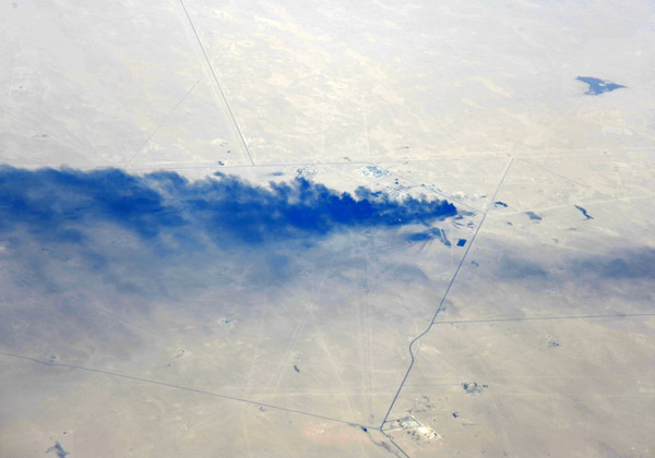 Black smoke plume from an oil installation near Basra, Iraq