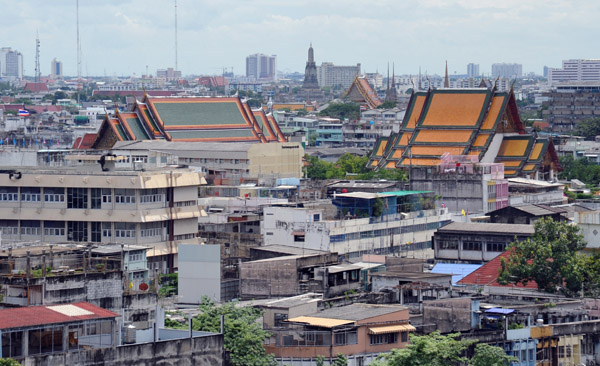 Roofs of other temples standing out against the rather drab constructions common in Bangkok 
