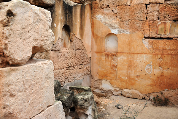 Original plaster and a pair of alcoves inside the ruins of a house