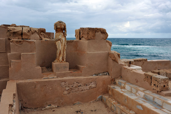 Statue overlooking a pool of the Seaward Baths, Sabratha