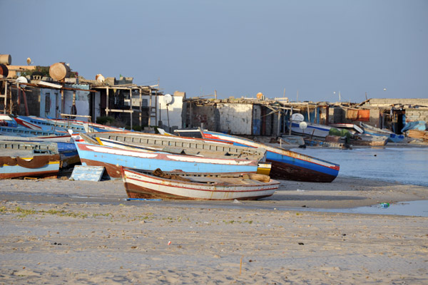 Fishing boats pulled up on the beach at Al Khoms
