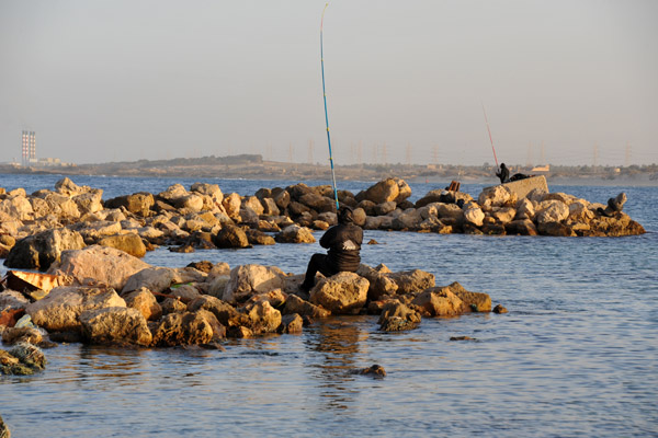 Fishing from the breakwater, Al Khoms