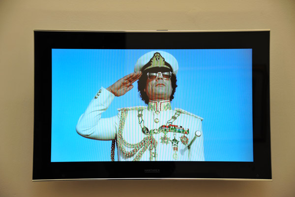 Qadhafi salutes on a video playing in the Gallery of the Revolution of the Museum of Libya, Tripoli