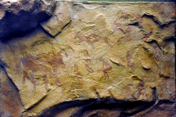 Prehistoric cave painting of hunters armed with bows