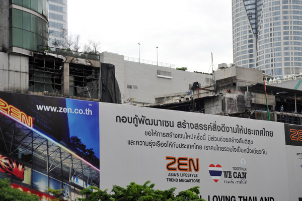 A large billboard hiding the burned out shell of Zen and Central World, Aug 2010