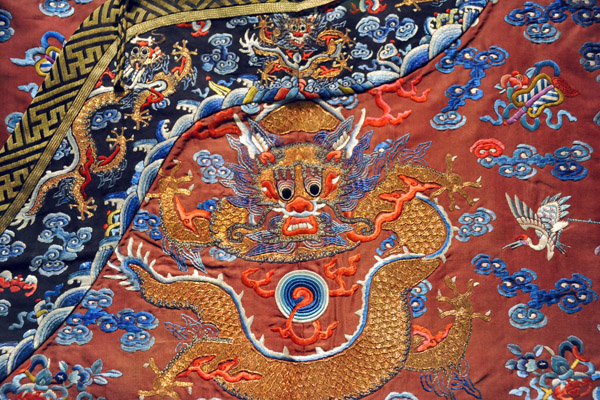 Detail of the young emperor's court robe with a dragon encircling the Pearl of Wisdom