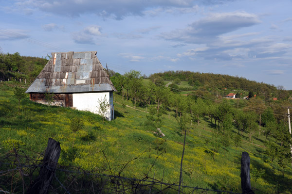 Barn in a hillside meadow in need of some roofwork