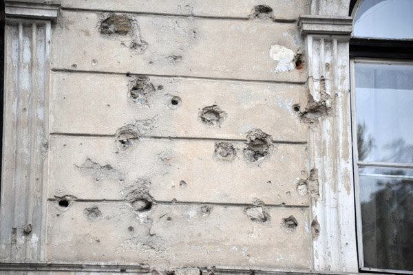 Bullet holes scarring a faade