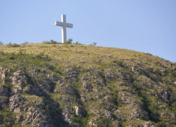 Cross on a hilltop overlooking the ethnically divided city of Mostar