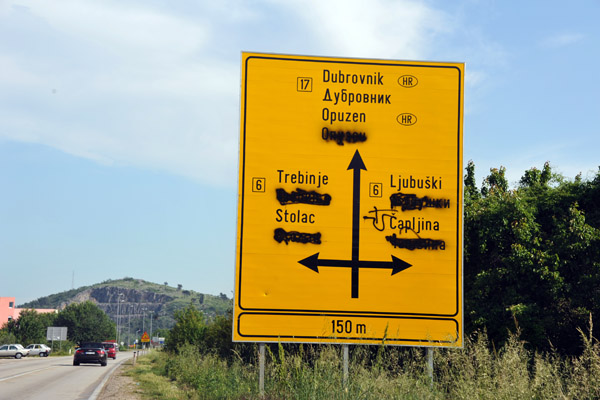 Road sign with the Cyrillic spray painted over - I'm turning left here