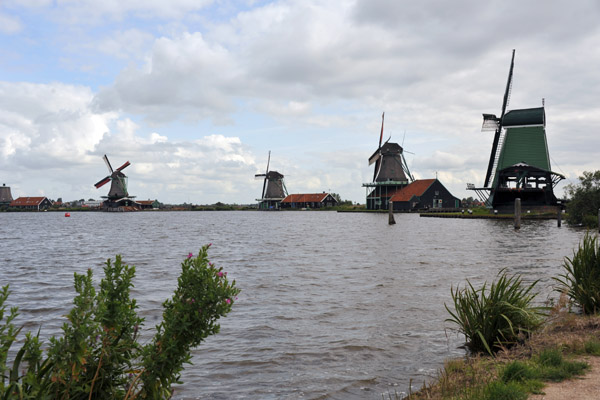 The famous row of old Dutch windmills on the Zaan River along the Kalverringdijk, Zaanse Schans