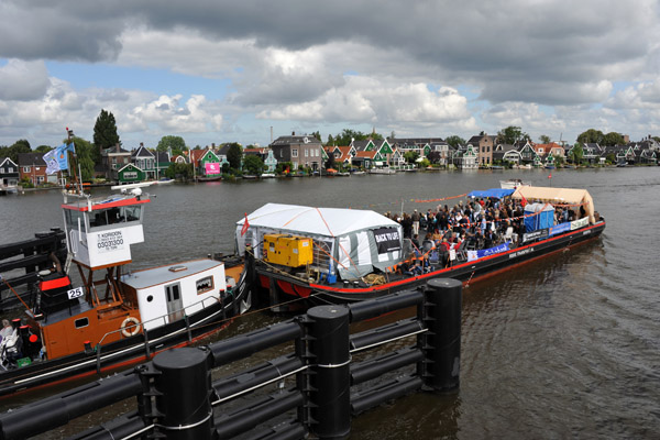 Tugboat pushing a party barge through the Julianabrug, River Zaan
