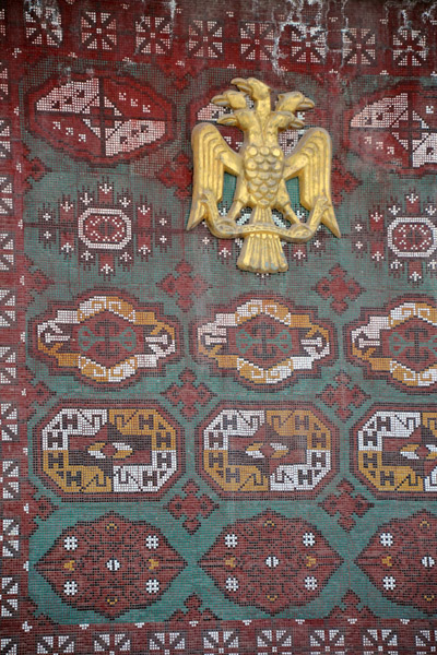 The five-headed eagle of Turkmenistan on a mosaic of the national symbols