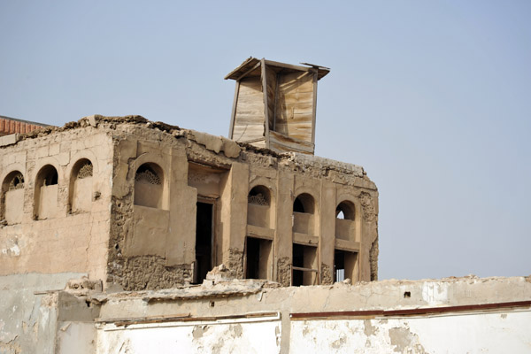Crumbling building with a wooden wind tower, Sharjah - Al Mareija