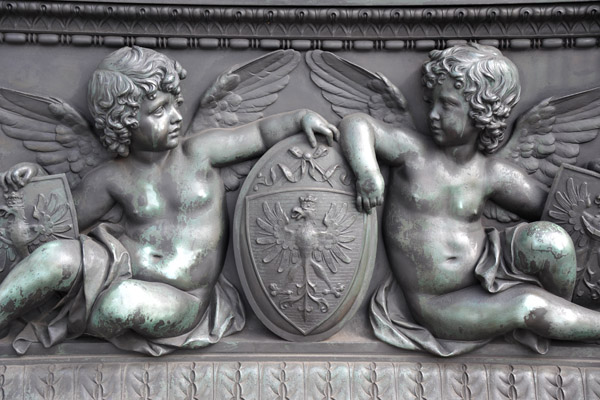 Bronze relief of cherubs holding shields with the Tyrollean eagle