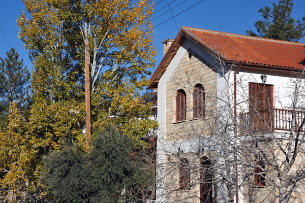 Stone house in Mandria with a red tile roof - autumn in Cyprus