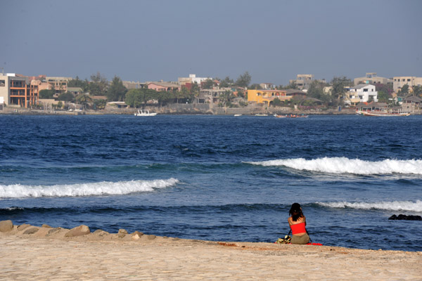 Woman on the jetty with île de Ngor in the background