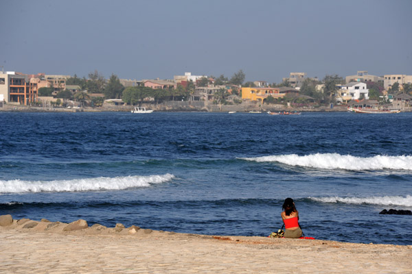 Woman on the jetty with le de Ngor in the background