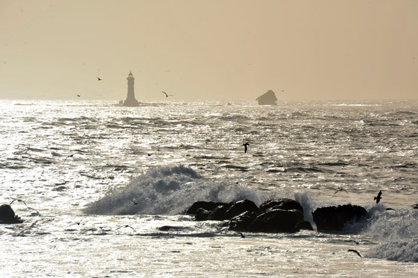 Lighthouse with a shipwreck off Pointe des Almadies