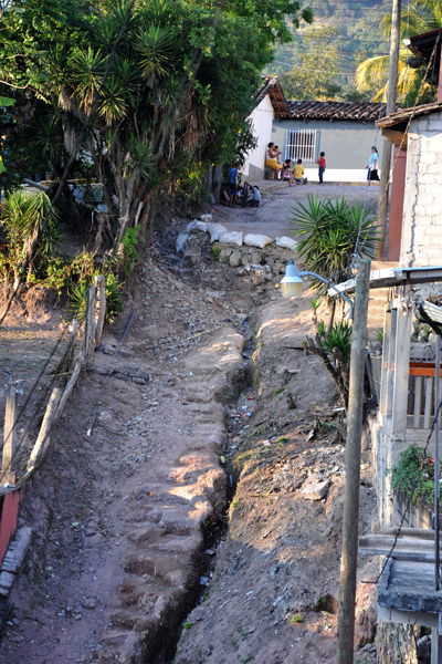 Major erosion to a street on the steep hillside of the upper town, Copan Ruinas