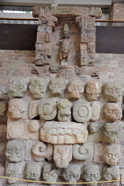 Detail from the west staircase of Structure 16 with skulls and a Tlaloc mask