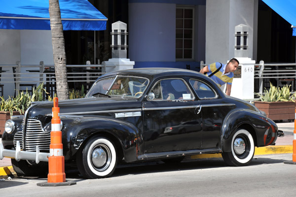 1940 Buick Super coupe parked in front of the Park Central Hotel, Ocean Drive
