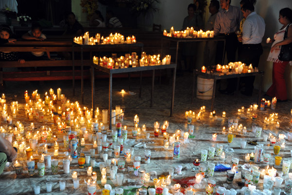 Candles on the church floor during a religious festival, Flores