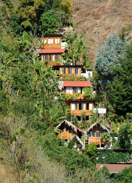 The cabins of Islaverde set precariously in a gully