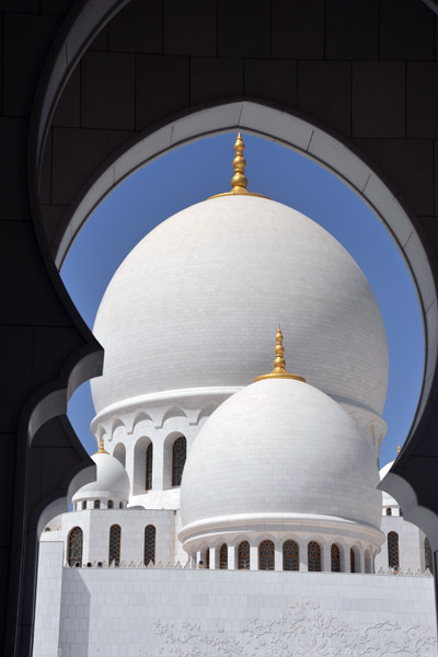 Domes of the Sheikh Zayed Mosque through Moorish arch