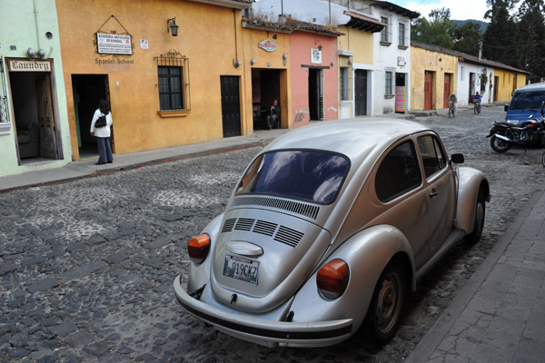 VW Beetle parked across from one of Antigua Guatemala's Spanish schools