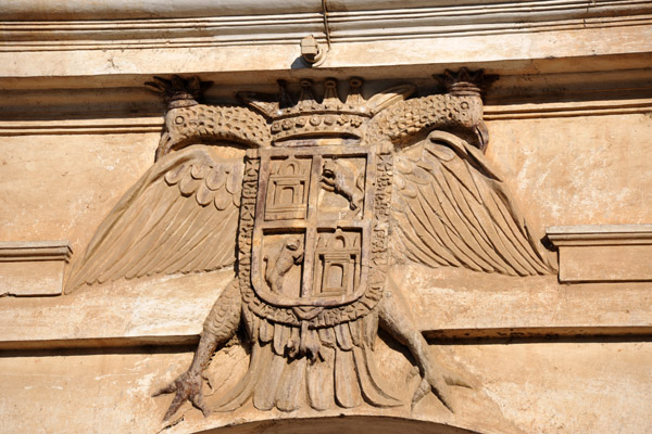 A double headed eagle with the simplified arms of Castile and Len 