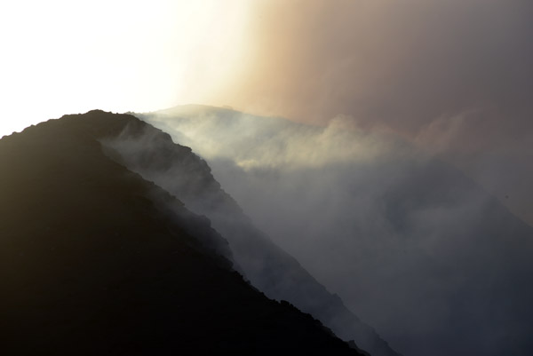 Ash, steam and cloud mix along the rim of Mt. Yasur