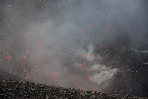Hot lava shooting up from within the crater, Mt. Yasur