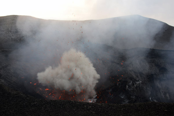 A strong explosion sends lava bombs higher than the level of the crater rim