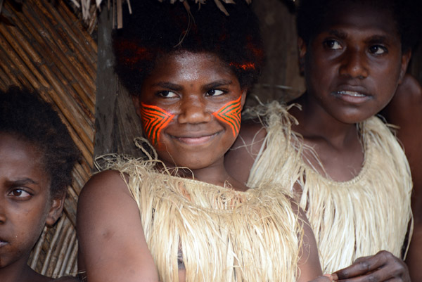 Young Yakel woman wearing orange face paint