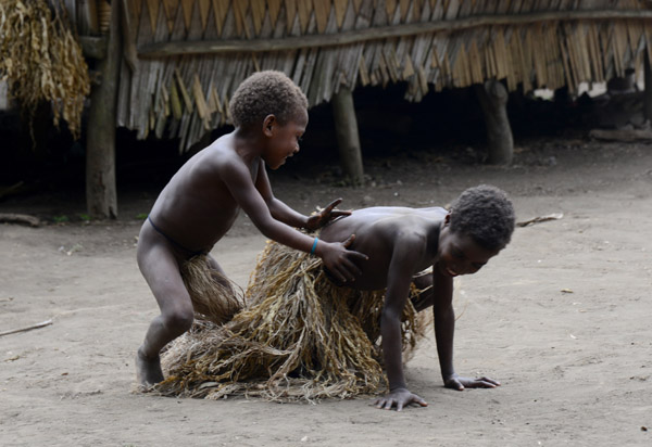 A young Yakel boy playing with a girl