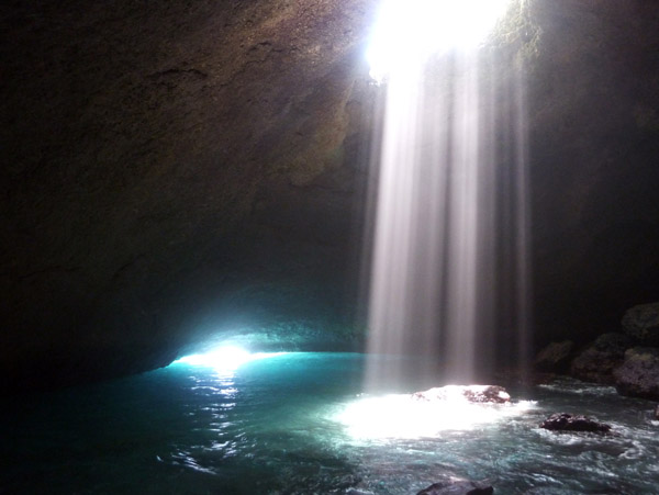 Sunlight pours in through a hole in the roof of the Blue Cave