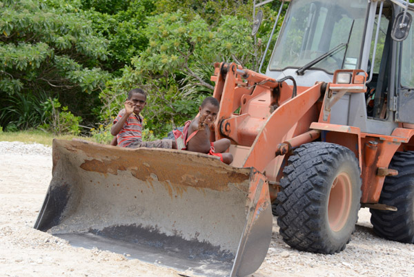 Kids in Tanna waving from a bulldozer