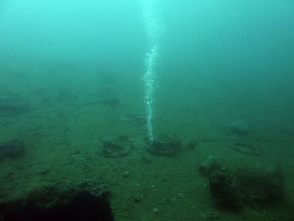 Bubbles emerging from divers inside the wreck of the Coolidge