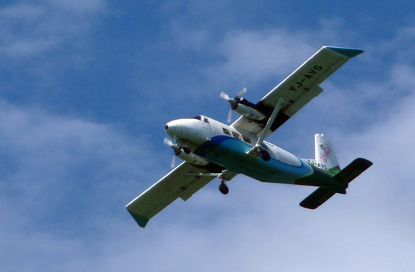 An Air Vanuatu Twin Otter (YJ-AV5) flies over Million Dollar Point while landing at Luganville