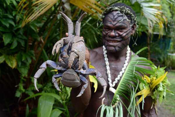 The guide holds up the Coconut Crab, Secret Garden