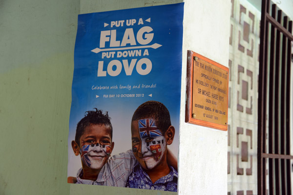 Put up a flag, put down a lovo - a poster in Suva