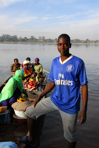 Pirogue ferryman (Nomory Sow from Babaroto, Mali) in a Fly Emirates shirt