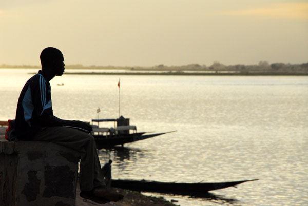 Man contemplating the Niger, late afternoon