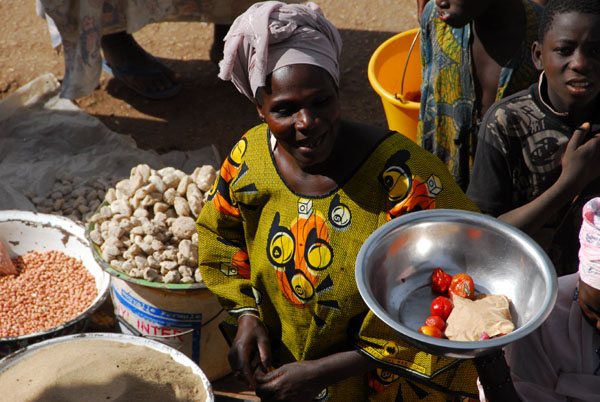 All the woman at the market are wearing colorful West African clothing