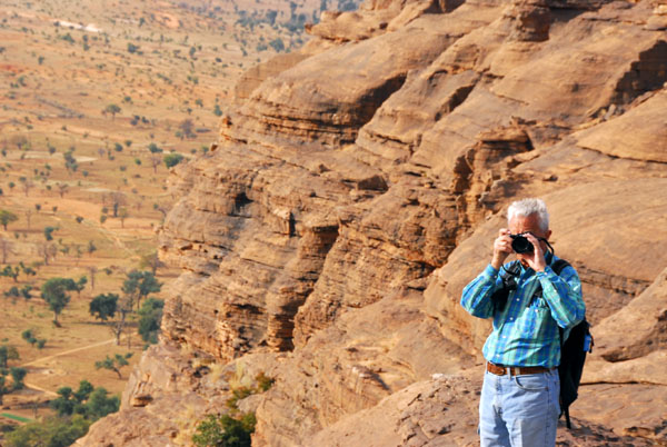 Udo taking a photo from the top of the Dogon escarpment