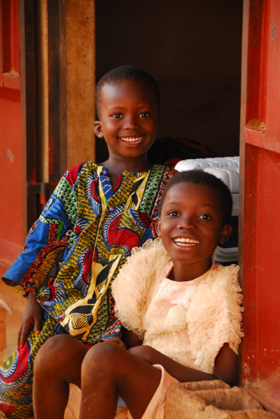 Boy in a beautiful West African shirt and girl in a frilly dress, Abomey