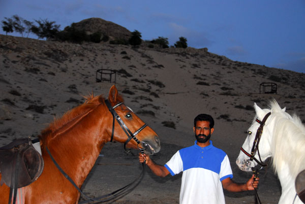 The horseman with our mounts at the base of Ras Sawadi